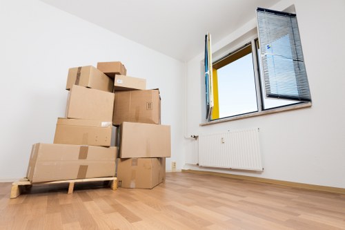 Packed boxes and furniture prepared for storage near Stjohnswood